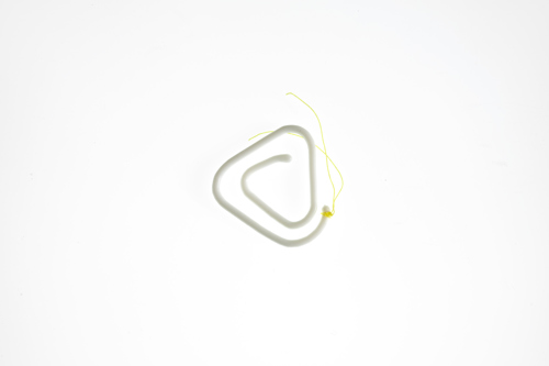 white contraception coil with yellow thread